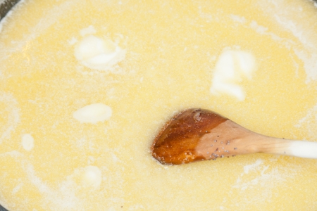 Butter melting on frying pan in preparation for cooking food.の写真素材