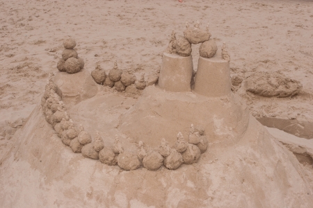 Sand castle is a type of sand sculpture resembling a miniature building, often a castle.の写真素材