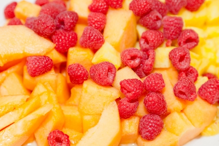 Salad made of yellow honeydew melon and raspberries.の写真素材