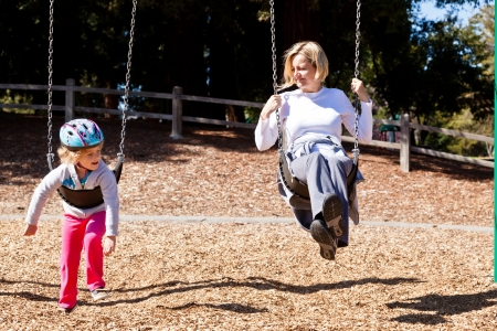Having fun at playground in the park on sunny afternoon.の写真素材