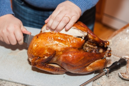 Whole uncarved roasted turkey on party table.の写真素材