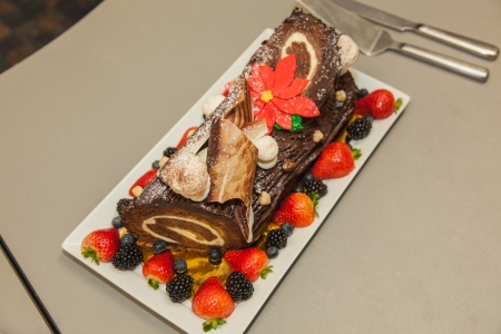 Beautifully decorated delicious chocolate layered roll. on rectangle plate.の写真素材