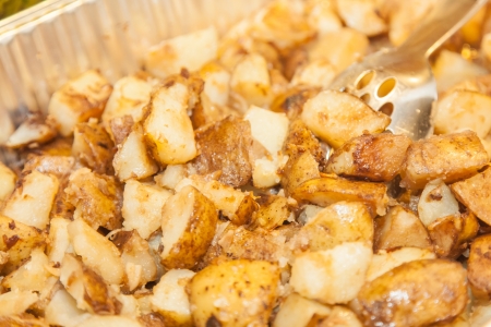 Roast potato cubes have a flavorful and crispy exterior from high baking temperatures. Despite the crisped exterior, the innards of the potato cubes remain fluffy and moist.の写真素材