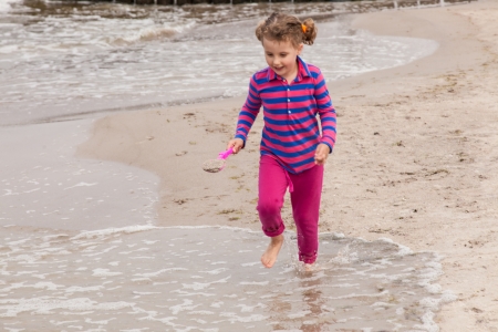 Having fun with sand on the beach.の写真素材