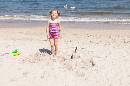 Having fun with sand on the beach.の写真素材