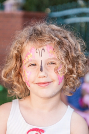 Having fun with face paited during birthday party.