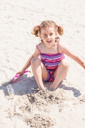 Having fun with sand on the beach.の写真素材