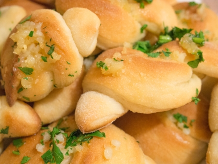 Warm freshly baked home made yeast croissants garnished with parsley and garlic.の写真素材