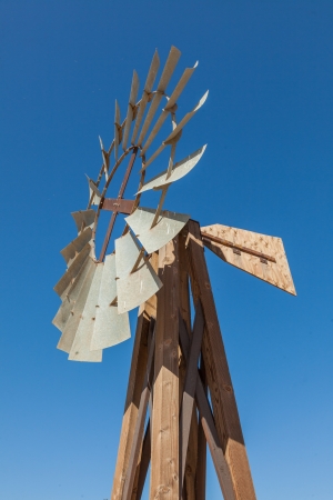 Old farm style water pumping windmill at local farm.の写真素材