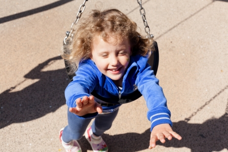 Having fun at playground in the park on sunny afternoon.