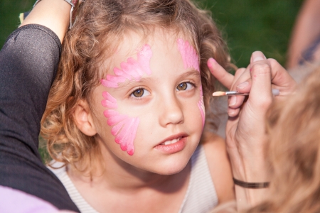 Having fun with face paited during birthday party.