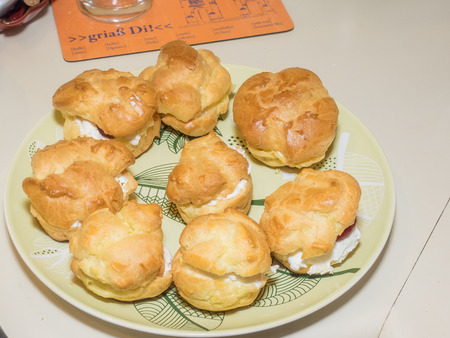 Homemade choux pastry ball filled with whipped cream, pastry cream.の写真素材