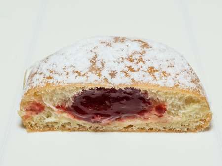 Delicious strawberry jelly filled doughnut cut in halfの写真素材