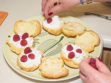 Homemade choux pastry ball filled with whipped cream, pastry cream.