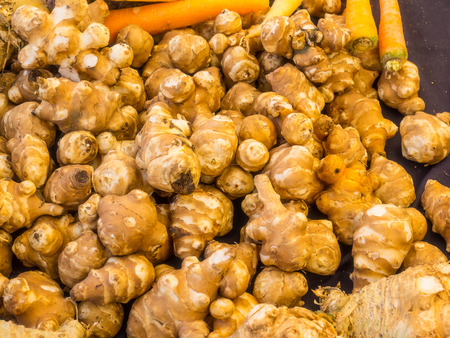 Pile of organic ginger root for sale at local farmers market.