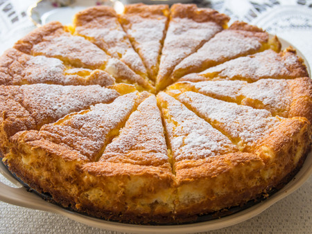 Traditional polish style cheesecake cut into pieces.