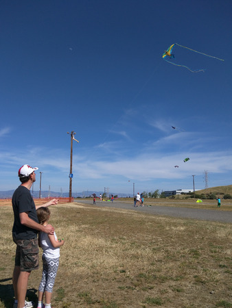 Having fun flying a kite on hot summer day.の写真素材
