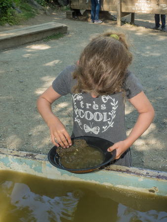 Gold panning is a form of placer mining and traditional mining that extracts gold from a placer deposit using a pan.の写真素材