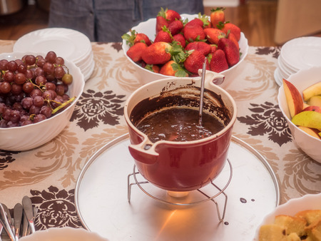 Hot melted chocolate ready for fondue during party.の写真素材