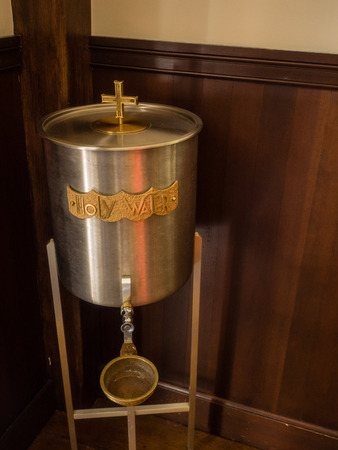 Holy water bucket inside Roman Catholic church.の写真素材
