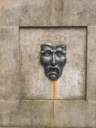 Fountain on Royal Mile in Edinburgh with the happy face/sad face symbol.の写真素材