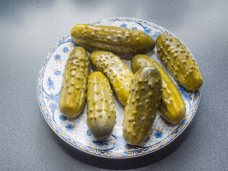 Pickled cucumber is a cucumber that has been pickled in a brine, vinegar, or other solution and left to ferment for a period of time, by either immersing the cucumbers in an acidic solution or through souring by lacto-fermentation.の写真素材
