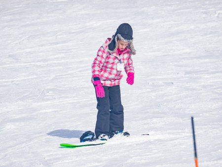Beginner kids snowboarding lesson is the fastest way to learn skills and safety.の写真素材