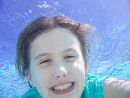 Having fun in water on hot day.の写真素材