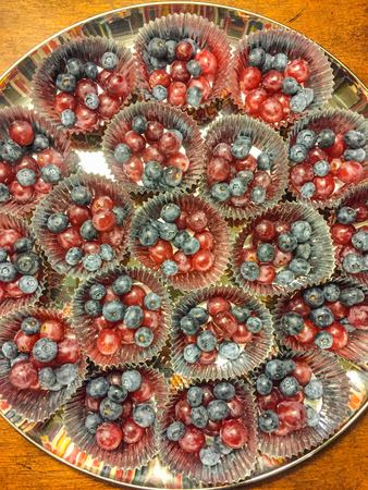 Mixed blueberries and grapes in cupcake liners