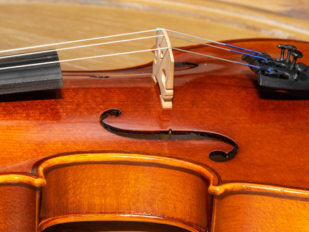 Violin, also known informally as a fiddle, is a wooden string instrument in the violin family. Most violins have a hollow wooden body. It is the smallest and highest-pitched instrument in the family in regular use.の写真素材