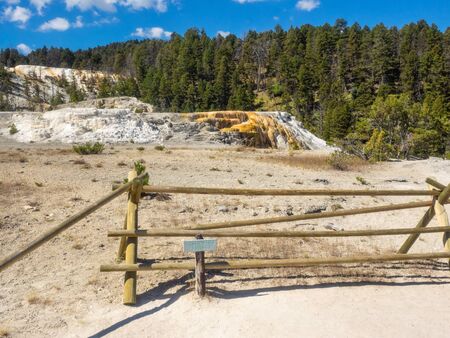 Mammoth Hot Springs is a large complex of hot springs on a hill of travertine in Yellowstone National Park. The hot water that feeds Mammoth comes from Norris Geyser Basin after traveling underground via a fault line that runs through limestone.の写真素材