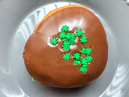 St. Patrick's Day green glazed doughnut is a traditional yeast donut made with green-tinted dough.の写真素材