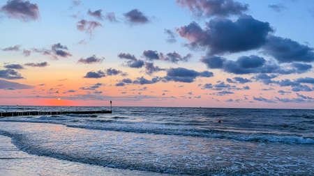 Enjoying summer sunset on the beach in Kolobrzeg.