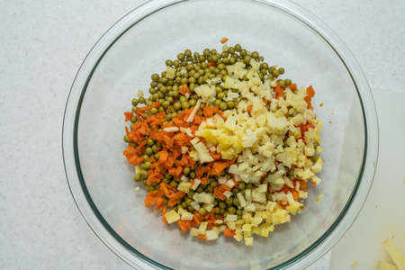 Salade Olivier is a salad composed of diced potato, vegetables and sometimes meats bound in mayonnaise.の写真素材