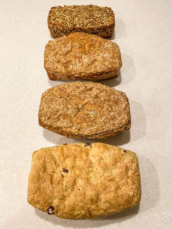 Bread is a staple food prepared from a dough of flour (usually wheat) and water, usually by baking. Throughout recorded history and around the world, it has been an important part of many cultures' diet. It is one of the oldest human-made foods, having been of significance since the dawn of agriculture, and plays an essential role in both religious rituals and secular culture.の写真素材