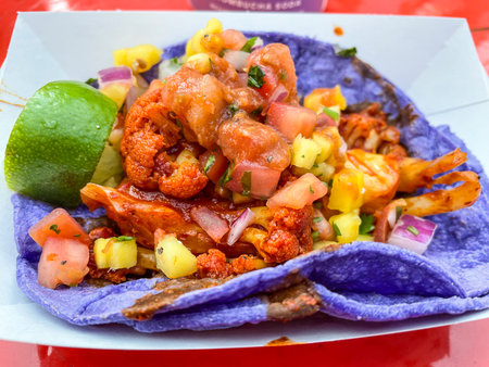 Taco is a traditional Mexican food consisting of a small hand-sized corn- or wheat-based tortilla topped with a filling.の写真素材