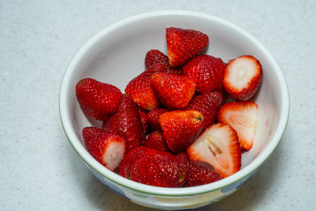 Fresh strawberries (Fragaria Ã ananassa) in a bowl, ready to be enjoyed!の写真素材
