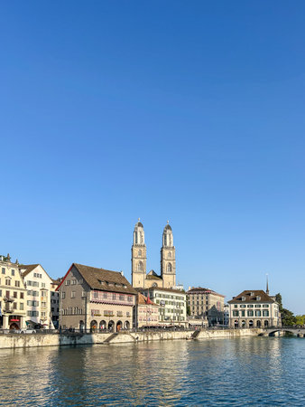 View of the Limmat river with the GrossmÃ¼nster church in the background. Zurich, Switzerland.の写真素材