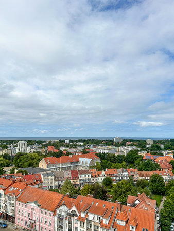 A scenic view of KoÅ‚obrzeg, Poland showcasing its architecture against the backdrop of the...