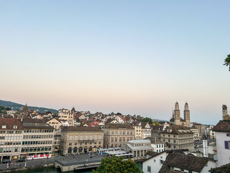 A scenic view of Zurich, Switzerland, featuring GrossmÃ¼nster church, taken from Lindenhof during the early evening light.の写真素材