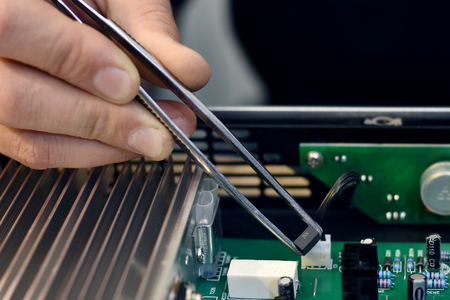 Repairman disassembling. Unrecognizable man holding computer circuit in electronics repair service,...