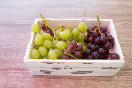 Grapes in a wood cabbageの写真素材