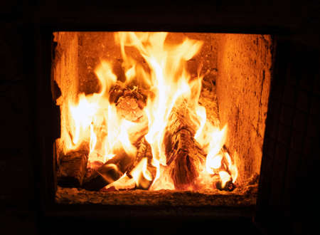 The oven door is open, the wood is burning brightlyの写真素材