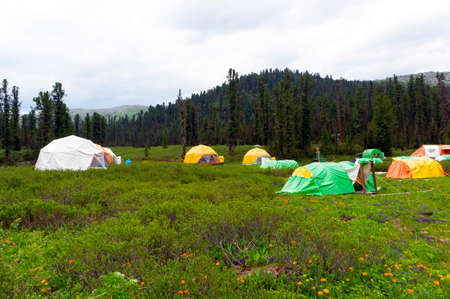 Tent camp in the mountain taiga forest. Ergaki National Park, Krasnoyarsk Territory, southern...