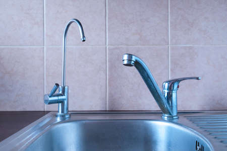 Sink in the kitchen with two taps - one for drinking filtered water, the second for washing dishes