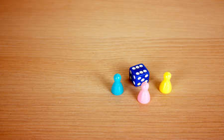 Dice and multi-colored chips lie on the table. Place for textの写真素材