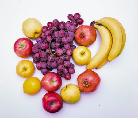 Fruits on a white background. Grapes, apples, lemon, pomegranate, bananasの写真素材