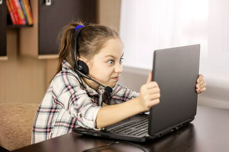 Teen girl is angry at a laptop