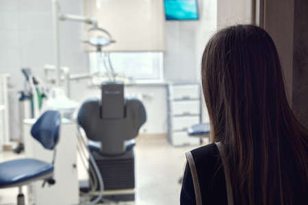 Teenage girl looking at the dentists officeの写真素材