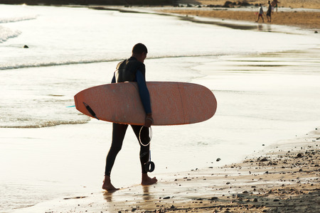 surfer in the beach shore  at duskの写真素材
